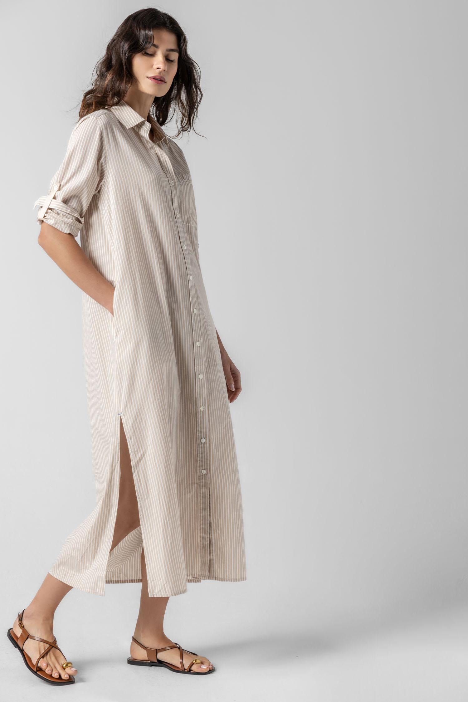 <p>In crisp poplin, the Striped Maxi Shirt Dress offers versatility and effortless ease. Designed with tabs on the sleeves, it can be worn rolled up or down to suit your mood. With tall side slits and a full button-down front, this dress can double as a duster over shorts or white denim for added styling options. An optional natural rope belt allows you to wear it cinched or loose, making it a perfect choice for summer days and beyond.</p> Womens Dress Flax Stripe A2