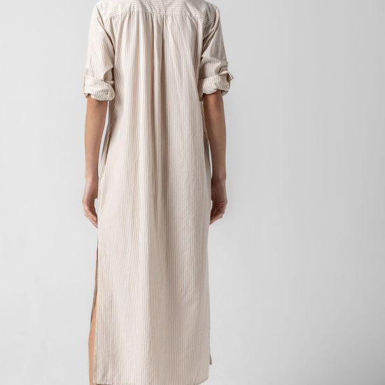 <p>In crisp poplin, the Striped Maxi Shirt Dress offers versatility and effortless ease. Designed with tabs on the sleeves, it can be worn rolled up or down to suit your mood. With tall side slits and a full button-down front, this dress can double as a duster over shorts or white denim for added styling options. An optional natural rope belt allows you to wear it cinched or loose, making it a perfect choice for summer days and beyond.</p> Womens Dress Flax Stripe A3