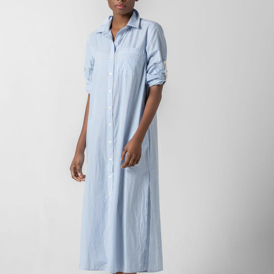 <p>In crisp poplin, the Striped Maxi Shirt Dress offers versatility and effortless ease. Designed with tabs on the sleeves, it can be worn rolled up or down to suit your mood. With tall side slits and a full button-down front, this dress can double as a duster over shorts or white denim for added styling options. An optional natural rope belt allows you to wear it cinched or loose, making it a perfect choice for summer days and beyond.</p> Womens Dress Malibu Stripe A1
