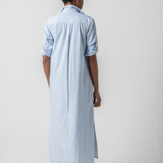 <p>In crisp poplin, the Striped Maxi Shirt Dress offers versatility and effortless ease. Designed with tabs on the sleeves, it can be worn rolled up or down to suit your mood. With tall side slits and a full button-down front, this dress can double as a duster over shorts or white denim for added styling options. An optional natural rope belt allows you to wear it cinched or loose, making it a perfect choice for summer days and beyond.</p> Womens Dress Malibu Stripe A2
