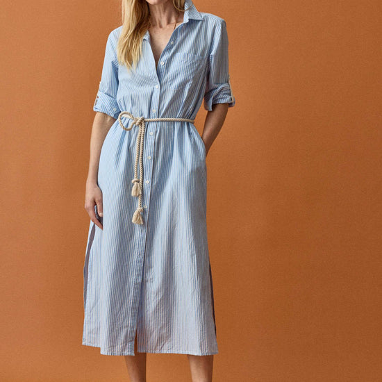 <p>In crisp poplin, the Striped Maxi Shirt Dress offers versatility and effortless ease. Designed with tabs on the sleeves, it can be worn rolled up or down to suit your mood. With tall side slits and a full button-down front, this dress can double as a duster over shorts or white denim for added styling options. An optional natural rope belt allows you to wear it cinched or loose, making it a perfect choice for summer days and beyond.</p> Womens Dress Malibu Stripe C1