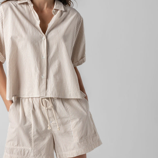<p>In crisp poplin, the Striped Boxy Button Down features an oversized fit and shorter length for a relaxed, effortless look. The messy rolled cuffs add to its casual look, making it an easy choice for warm days. Pair it with the coordinating Striped Pocket Short for a head-to-toe look, or style it with one of our Air Textured Cotton bottoms for a balanced solid option.</p> Womens Top Flax Stripe A2