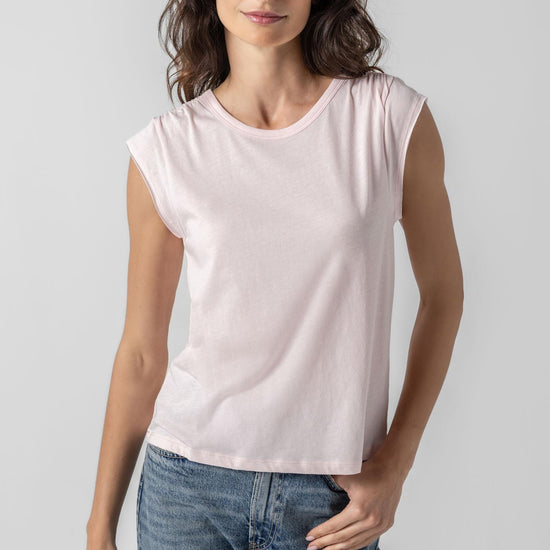 <p>In our Soft Wash Jersey fabric, the Shirred Shoulder Tee is both feminine and versatile for warm summer days. With a small cap sleeve and elastic with delicate shirring at the shoulder, itâ€™s designed to skim the body without being too fitted. Perfectly simpleâ€”yet anything but basic.</p> Womens Top Blush A1