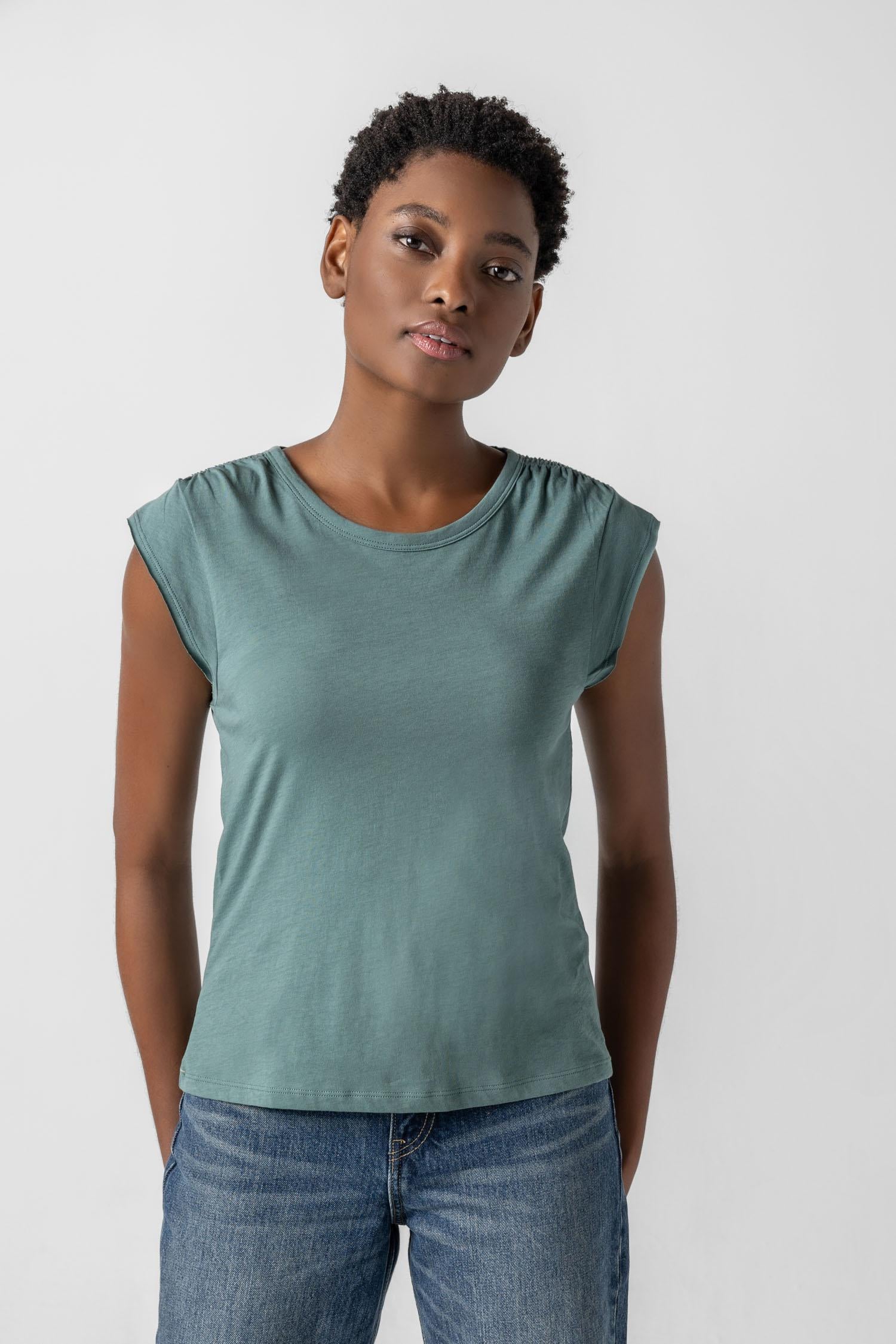 <p>In our Soft Wash Jersey fabric, the Shirred Shoulder Tee is both feminine and versatile for warm summer days. With a small cap sleeve and elastic with delicate shirring at the shoulder, itâ€™s designed to skim the body without being too fitted. Perfectly simpleâ€”yet anything but basic.</p> Womens Top Vine A1