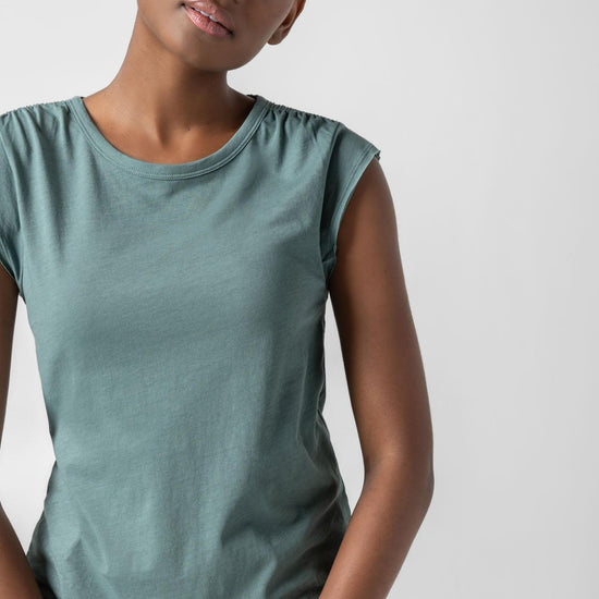 <p>In our Soft Wash Jersey fabric, the Shirred Shoulder Tee is both feminine and versatile for warm summer days. With a small cap sleeve and elastic with delicate shirring at the shoulder, itâ€™s designed to skim the body without being too fitted. Perfectly simpleâ€”yet anything but basic.</p> Womens Top Vine A2