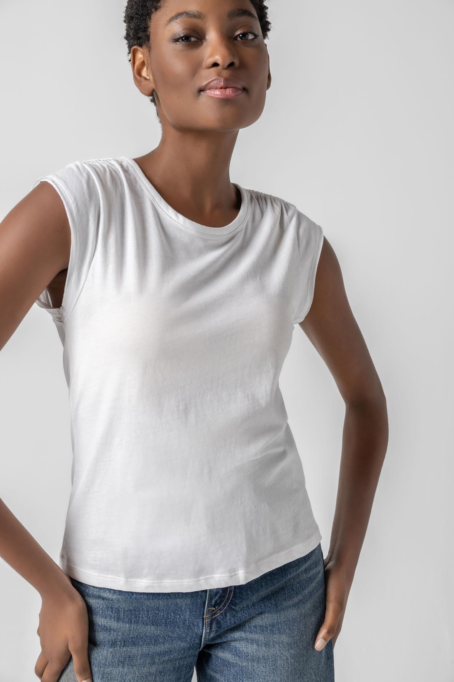<p>In our Soft Wash Jersey fabric, the Shirred Shoulder Tee is both feminine and versatile for warm summer days. With a small cap sleeve and elastic with delicate shirring at the shoulder, itâ€™s designed to skim the body without being too fitted. Perfectly simpleâ€”yet anything but basic.</p> Womens Top White A1