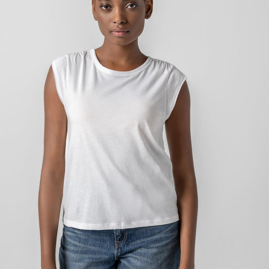 <p>In our Soft Wash Jersey fabric, the Shirred Shoulder Tee is both feminine and versatile for warm summer days. With a small cap sleeve and elastic with delicate shirring at the shoulder, itâ€™s designed to skim the body without being too fitted. Perfectly simpleâ€”yet anything but basic.</p> Womens Top White A2