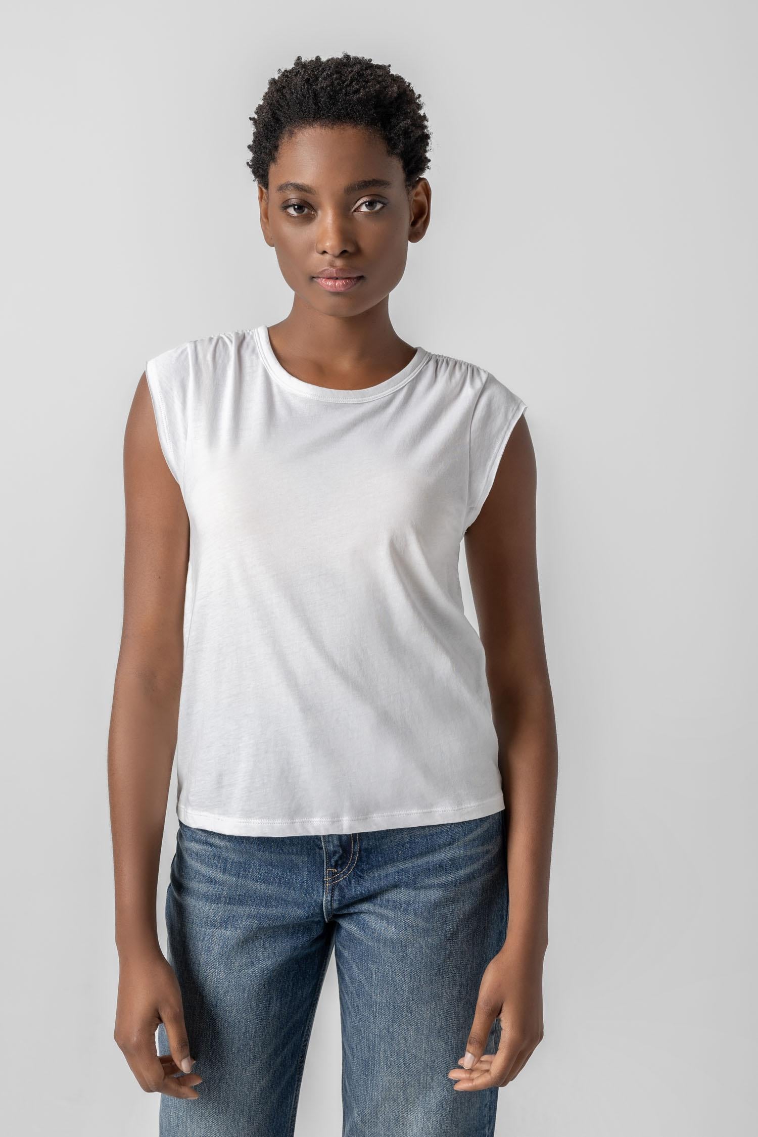 <p>In our Soft Wash Jersey fabric, the Shirred Shoulder Tee is both feminine and versatile for warm summer days. With a small cap sleeve and elastic with delicate shirring at the shoulder, itâ€™s designed to skim the body without being too fitted. Perfectly simpleâ€”yet anything but basic.</p> Womens Top White A2